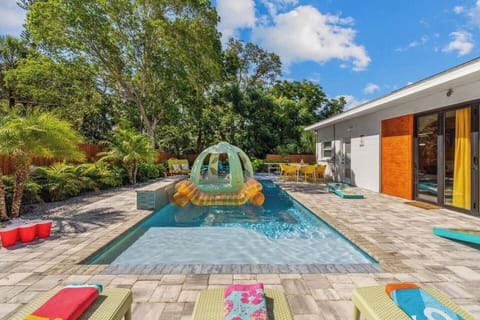 Soak up the south Florida sun while  surrounded by tropical landscaping by the heated salt water pool with LED waterfall, Funboy floats and a smokeless firepit. 