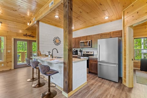 rustic kitchen with granite countertops and stainless steel appliances