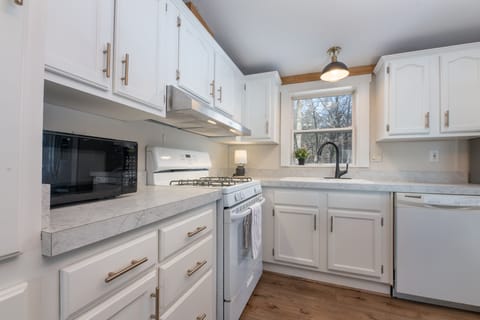 Fully stocked kitchen offers all appliances, cookware, utensils, and dinnerware