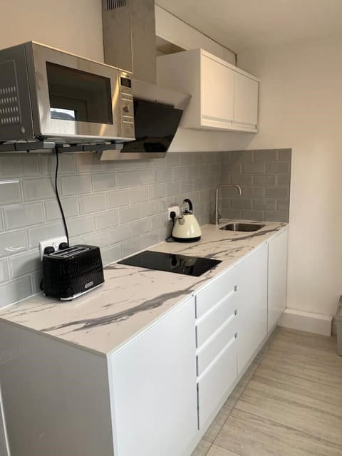 Dual burner stove, microwave oven / grill, kettle, toaster and fridge.