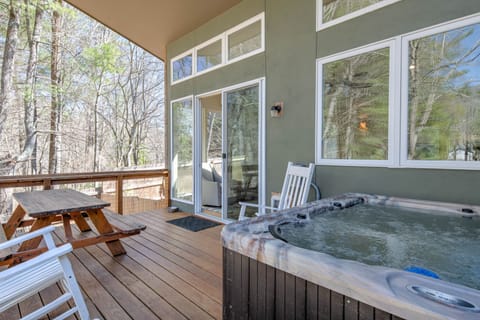 Partially covered rear deck and 5-person hot tub.  Soak in the rain!