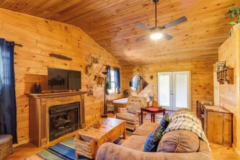 Relax in a cabin that blends rustic warmth with a contemporary black fireplace.