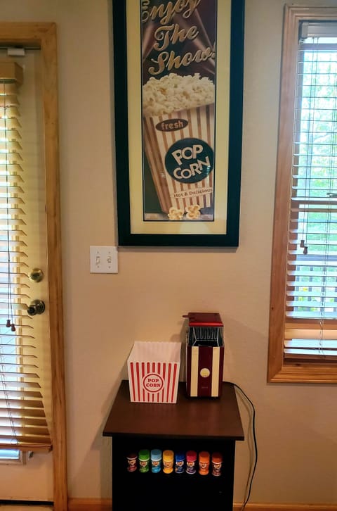 Popcorn station with vintage-style air popper in movie area - kernels provided.