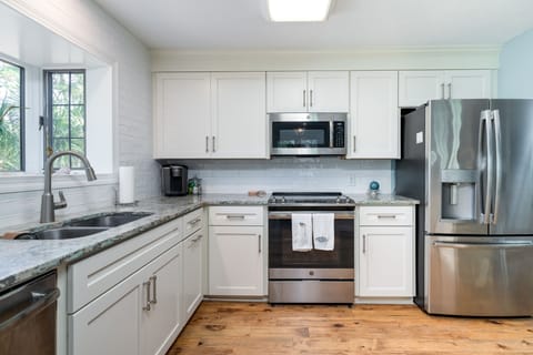 The kitchen has new custom cabinets, tiled back splash and stainless steel appliances