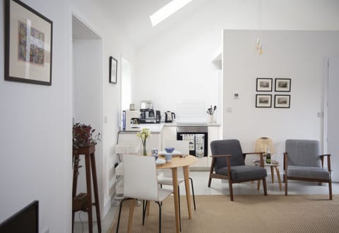 Interior of open plan living room with fully equipped kitchen and dining table 