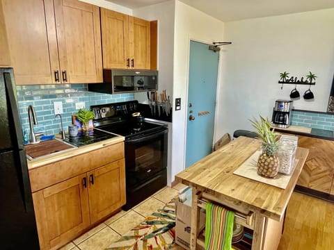 Full kitchen with all the cookware and appliances, including a coffee machine.