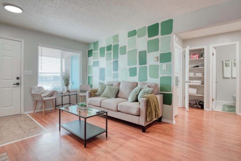 The painted walls in varying shades of green create a refreshing and tranquil atmosphere, complemented by lush indoor plants that bring nature indoors.