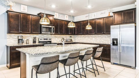 Modern kitchen with granite counters and bar seating