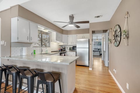 View as you enter the kitchen from the living room.  Bedroom 1 can be seen down the hall.