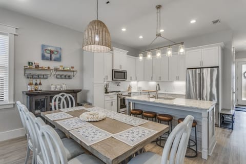 An indoor table and bar island seating as well as outdoor dining. 