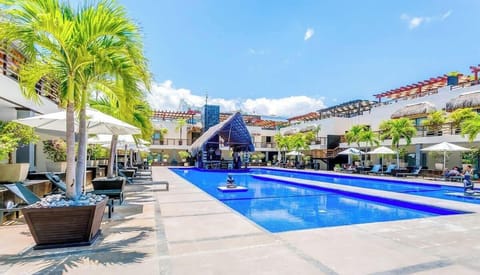 The Aldea Thai pool has a swim-up bar & lounge areas to enjoy