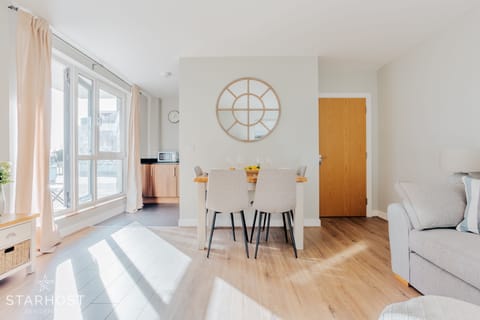 The living room provides access to the kitchen, with a range of appliances