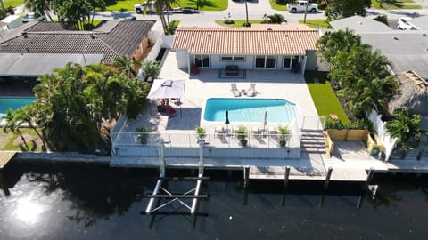 Aereal View of the property. Water canal behind the pool area and backyard.