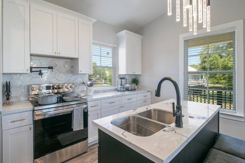 "Unleash Your Inner Chef: Fully Equipped Kitchen with Flat Top Stove, Double Sink, Dishwasher, Pot Filler, Knives, Cookware, Bakeware, Toaster, Blender, and Garbage Disposal - Perfect for Preparing Delicious Meals and Creating Lasting Memories"