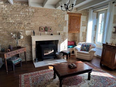 The downstairs living room is cozy and hosts a working fireplace!