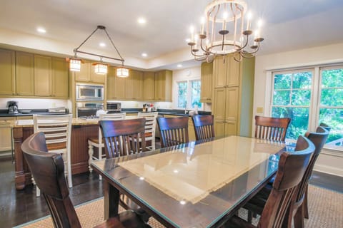 The dining table seats 8 and there are 3 additional stools at the center island.