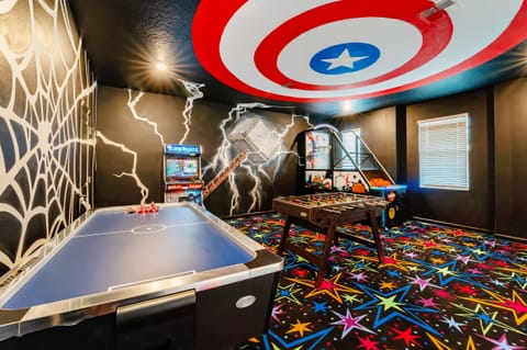Experience superhero adventures in this vibrant game room with air hockey, foosball, and arcade fun. Perfect for endless entertainment!