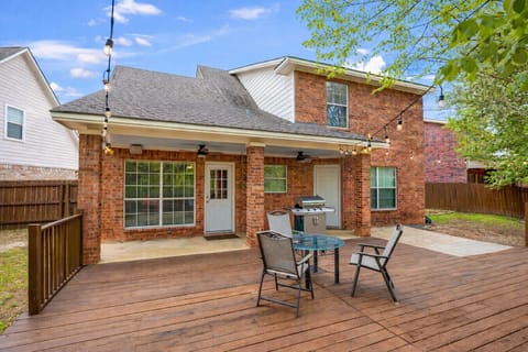 Deck in the backyard with seating and hanging lights
