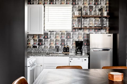 Fully equipped kitchen with drip coffee maker + coffee. Dining table with seating for 8. Full length mirror for getting ready. This room opens up into the living room. Unique wallpaper all throughout the condo.