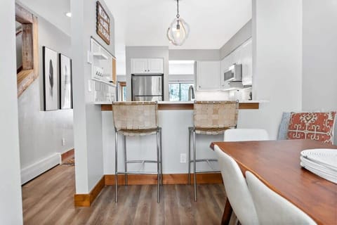 The view towards the bright kitchen from the dining room.