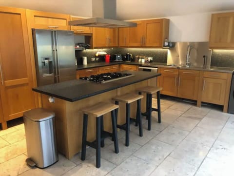 Great social kitchen area with 3 door oven on the back of the island & Aga Oven