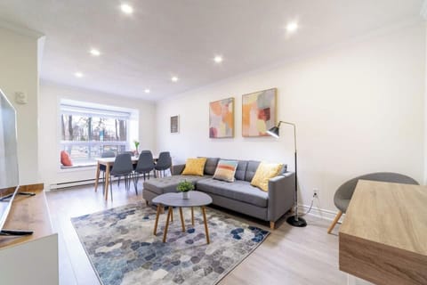 Tastefully decorated living room with comfortable Couch, Coffee table, Reading area and Work table. 