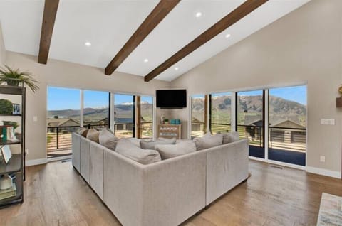 Living room with wrap-around deck.  Views of Pineview Reservoir, Snow Basin, and Nordic Valley.