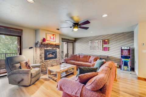 Living Room with plenty of seating, cozy gas fireplace, shuffleboard and pac man.