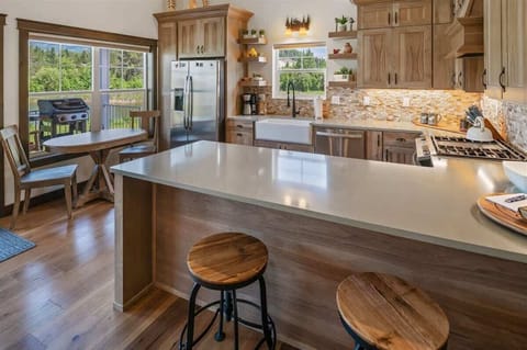 Fully appointed kitchen with bar seats and dining table