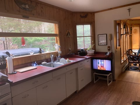 Fully stocked with silverware, pans, glassware, and coffee maker. No dishwasher.