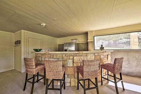 Try your hand at mixology behind this outdoor bar with fridge!