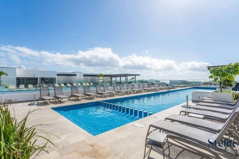 Unwind on the rooftop! Sparkling pool and lounge chairs with ocean views.


