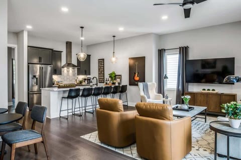 Open layout for cooking, relaxing, and dining with extra seats.