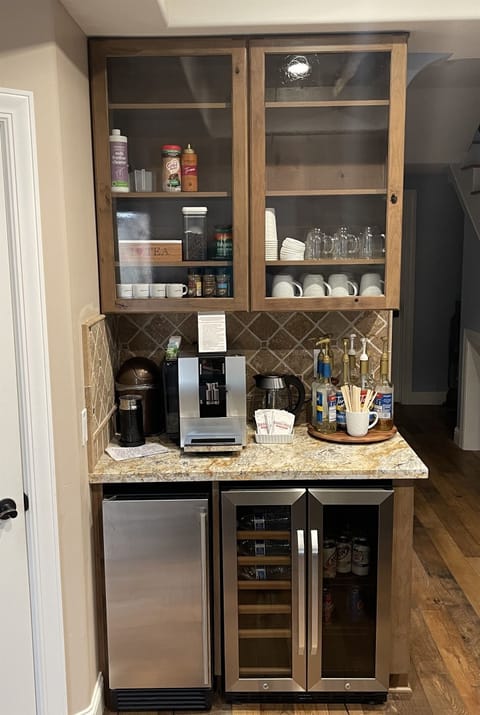 Jura super-automatic espresso/coffee maker with attached milk refrigerator for lattes/macchiatos.  We supply whole dark roast beans, sweeteners, flavored syrups.  We also have drip coffee maker and filters stored in pantry.