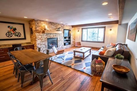 Gourmet kitchen opens to dining and living area complete with fireplace and tv.