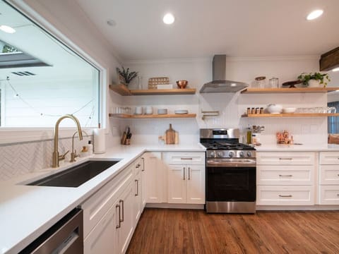 Our farmhouse style sink overlooks the back yard with a huge window and has a Water Drop water filter.