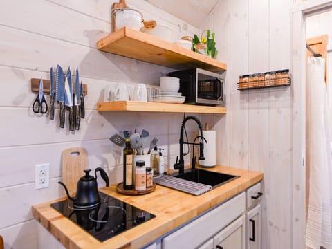 Electric stove with kettle are included in our fully-furnished kitchen.