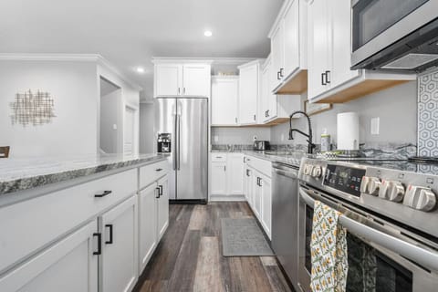 A modern kitchen with stainless steel appliances and all the essentials for your stay.