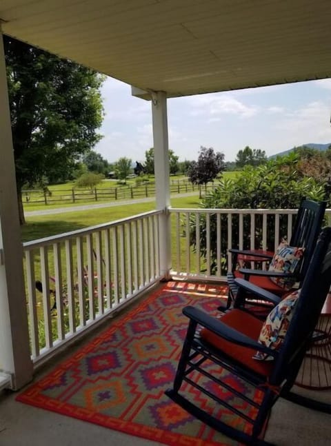 Enjoy morning coffee with views of mountains, fields and horses