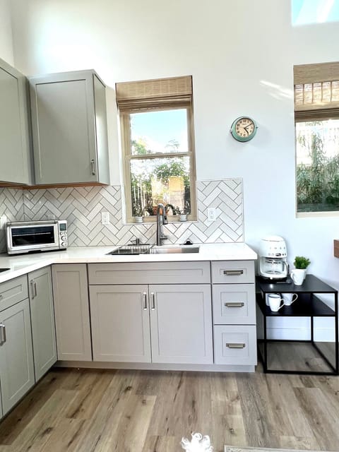 The kitchen. Large fridge, 2 burners stove and large Breville oven. 