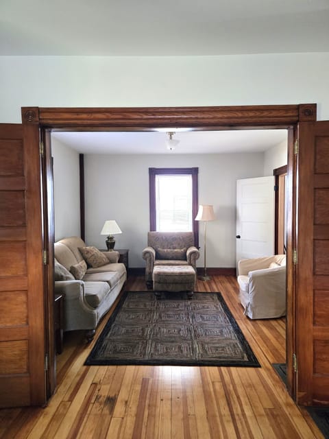 Easy flow from dining room to living room. Beautiful woodwork throughout.