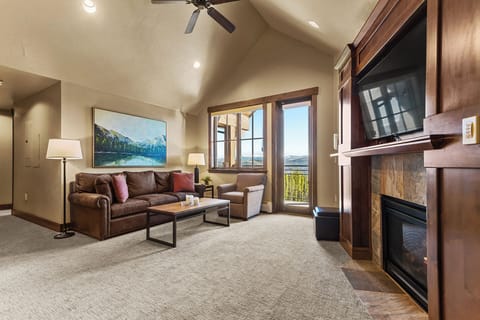 Bright living room with private balcony & fireplace
