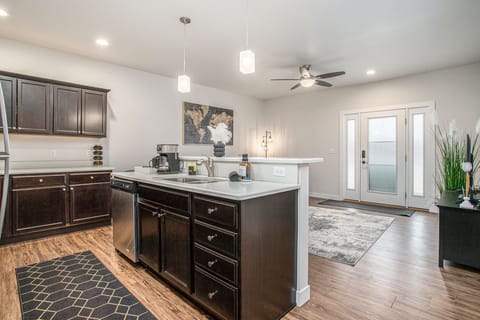 Entertain with ease in our open-concept kitchen, featuring modern appliances, with seamless views of the cozy living area.