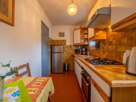 Cabinetry, Picture Frame, Furniture, Countertop, Kitchen Appliance, Kitchen Stove, Wood, Sink, Orange, Lighting