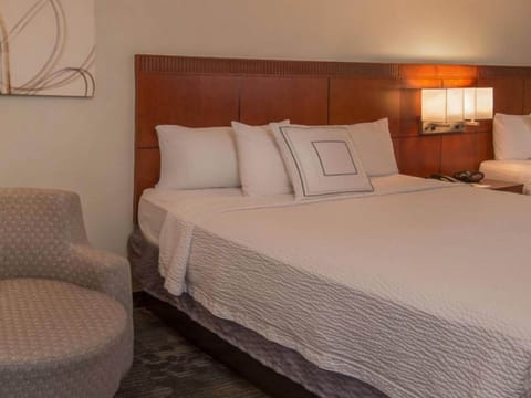 Drift off easily on a cloud-soft bed with warm lighting.