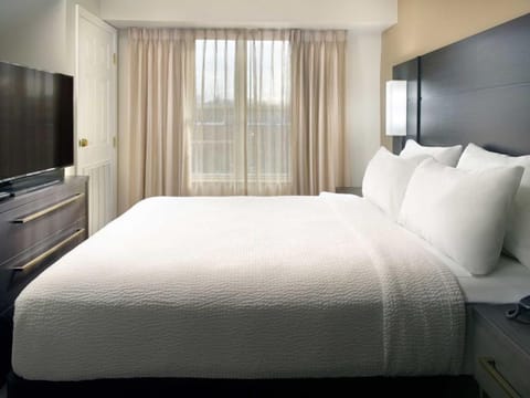 Drift off in crisp bedding with calming natural light.