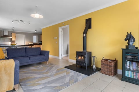 open plan reception room with log burner