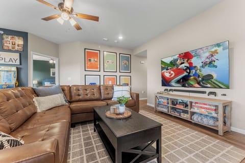 The living room holds a 75" TV with a Nintendo Switch.