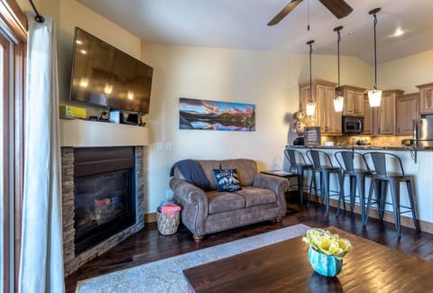 Living room with a ROKU TV, fireplace and lots of games and puzzles in the drawers of the coffee table
