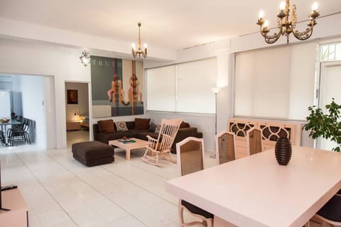 Luxuious living & dining area lmarble floor, high ceilinged with natural light.